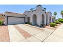 Inviting home featuring a tile roof, arched entryway, and a two-car garage at 16803 N 49Th Way, Scottsdale, AZ 85254