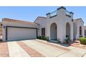 Inviting home featuring a tile roof, arched entryway, and a two-car garage at 16803 N 49Th Way, Scottsdale, AZ 85254