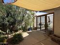 Beautiful backyard covered patio and tranquil landscaping, offering a serene outdoor space at 1725 N Date -- # 8, Mesa, AZ 85201