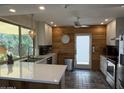 Bright kitchen with white cabinets, stainless appliances, quartz countertops, and an adjacent dining area at 1725 N Date -- # 8, Mesa, AZ 85201