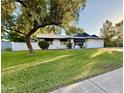 Inviting single-story home with a lush lawn and mature shade tree in the front yard at 1742 W Butler Dr, Phoenix, AZ 85021