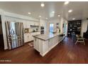 Modern kitchen with stainless steel appliances, a large island, and sleek white cabinets at 1742 W Butler Dr, Phoenix, AZ 85021