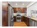 Well-equipped kitchen with stainless steel appliances, wood cabinets, and a functional layout at 17850 N 68Th St # 1017, Phoenix, AZ 85054