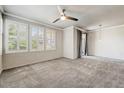 Bright bedroom featuring plush carpet, ceiling fan, and abundant natural light through shuttered windows at 20100 N 78Th Pl # 2019, Scottsdale, AZ 85255