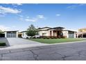 Charming modern home featuring unique architectural details, wood accents, and a stylish three-car garage at 2215 N 38Th Way, Phoenix, AZ 85008