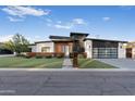 Modern home featuring unique architectural details, wood accents, and a stylish three-car garage at 2215 N 38Th Way, Phoenix, AZ 85008