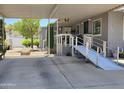 Home featuring a covered carport and ramp leading to the front door, set in a well-maintained community at 2233 E Behrend Dr # 121, Phoenix, AZ 85024