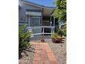 Inviting walkway with brick pavers leads to a cozy covered porch at 2233 E Behrend Dr # 17, Phoenix, AZ 85024