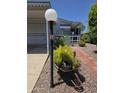 Landscaped front yard with desert plants, a lamp post, and covered carport at 2233 E Behrend Dr # 17, Phoenix, AZ 85024
