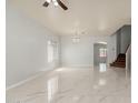 Bright living room featuring tile flooring, a chandelier, and arched doorways at 22966 W Hopi St, Buckeye, AZ 85326