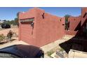 Single car garage with a rustic wood facade and a door matching the home's stucco color at 25449 W Pueblo Ave, Buckeye, AZ 85326