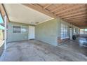 A spacious carport with a wooden ceiling and a door that leads to a screened porch at 2922 W Citrus Way, Phoenix, AZ 85017