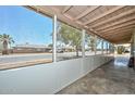 Covered screened porch that has views of the street and palm trees at 2922 W Citrus Way, Phoenix, AZ 85017