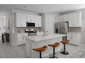Modern kitchen featuring an island with seating, stainless steel appliances, and white cabinetry at 3310 E Valleyhigh Trl, San Tan Valley, AZ 85143