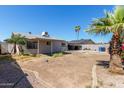 Backyard featuring desert landscaping and a covered patio area, perfect for outdoor living at 5807 W Encanto Blvd, Phoenix, AZ 85035