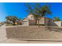 Two-story home featuring a tan stucco exterior and low-maintenance desert landscaping at 640 W Country Estates Ave, Gilbert, AZ 85233