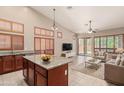 Open-concept kitchen and living area with high ceilings and stylish fixtures at 6936 E Snowdon St, Mesa, AZ 85207