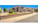 Charming two-story home with a well-manicured front yard featuring beautiful desert landscaping at 7725 W Dreyfus Dr, Peoria, AZ 85381