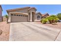 Attractive single-story home featuring a spacious driveway and well-maintained landscaping at 878 E Mountain View Rd, San Tan Valley, AZ 85143