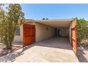 Spacious carport with wooden gate, providing shade and privacy at 9347 E Edgewood Ave, Mesa, AZ 85208