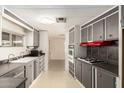Traditional kitchen with gray cabinets, laminate countertops, and modern appliances at 9347 E Edgewood Ave, Mesa, AZ 85208