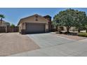 Charming single-story home featuring a two-car garage and desert landscaping at 9437 W Georgia Ave, Glendale, AZ 85305