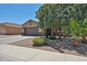 Charming single-story home featuring a two-car garage and desert landscaping at 9437 W Georgia Ave, Glendale, AZ 85305