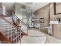 Elegant lobby with a grand staircase, chandelier, metal art feature and concierge desk at 945 E Playa Del Norte Dr # 1016, Tempe, AZ 85288