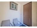 Welcoming front porch with seating and a view of the home's attractive front door at 9920 E Tamery Ave, Mesa, AZ 85212