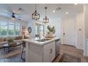 Open-concept kitchen featuring a center island, stainless steel appliances, and seamless flow to the living area at 1055 W Diamondback Dr, Chandler, AZ 85286