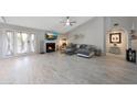Cozy living room features a fireplace and French doors leading to outdoor space at 11446 N 109Th St, Scottsdale, AZ 85259