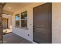 Inviting front entryway showcasing a modern door, stone pillar accents, and a glimpse of the interior at 13465 N 158Th Ave, Surprise, AZ 85379