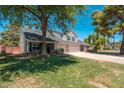 Charming two-story home featuring mature trees, well-manicured lawn, and an attached three car garage at 14622 N 45Th Pl, Phoenix, AZ 85032