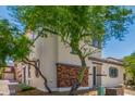 Inviting two-story home featuring low maintenance landscaping and a charming brick facade at 14885 W Ashland Ave, Goodyear, AZ 85395