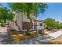Inviting two-story home featuring low maintenance landscaping and a charming brick facade at 14885 W Ashland Ave, Goodyear, AZ 85395