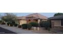 Charming single-story home with a stone arched entryway and meticulously landscaped front yard at 15861 W Westview Dr, Goodyear, AZ 85395