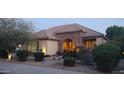 Inviting single-story home featuring a stone archway and well-maintained landscaping at 15861 W Westview Dr, Goodyear, AZ 85395