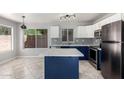 Modern kitchen with stainless steel appliances, quartz counters, island and ample cabinet space at 16626 N 20Th St, Phoenix, AZ 85022