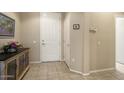 Light and airy entryway with tile flooring, white doors, and neutral paint at 17009 W Eureka Springs Dr, Surprise, AZ 85387