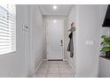 Bright entryway with neutral tile flooring and coat hooks to keep your space tidy at 17338 W Via De Luna Dr, Surprise, AZ 85387
