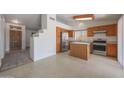 Spacious kitchen features stainless steel appliances, wooden cabinets, and ample counter space perfect for cooking at 17910 N 92Nd Ln, Peoria, AZ 85382