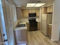 Bright kitchen with wood cabinets and appliances in neutral colors at 1825 W Ray Rd # 1008, Chandler, AZ 85224