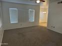 Spacious living room with neutral carpet and view to dining area through the opening at 1825 W Ray Rd # 1008, Chandler, AZ 85224