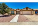 Charming single-story home with a two-car garage, manicured landscaping, and a welcoming walkway at 19206 N 40Th St, Phoenix, AZ 85050