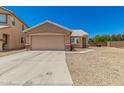 Charming home with two car garage, desert landscaping, and neutral colored exterior at 2018 N 104Th Dr, Avondale, AZ 85392