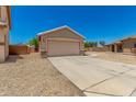 Charming single-story home featuring an attached two-car garage and low maintenance desert landscaping at 2018 N 104Th Dr, Avondale, AZ 85392