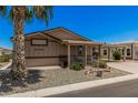 Inviting home featuring a quaint front porch, a convenient carport, and a desert landscape for easy upkeep at 2263 N Trekell Rd # 159, Casa Grande, AZ 85122