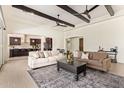 Spacious living room featuring dark wood beams, hardwood floors, and an open concept design at 24840 S 195Th St, Queen Creek, AZ 85142