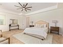 Bright main bedroom with neutral tones, a ceiling fan, carpet, and a cozy, relaxing ambiance at 24840 S 195Th St, Queen Creek, AZ 85142