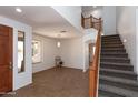Bright living room with tile flooring, a staircase, and ample natural light at 2527 E Remington Pl, Chandler, AZ 85286